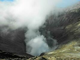 Close up of volcano crater spewing smoke at Mount Bromo photo