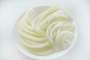 Chopped onion on a white plate. Fresh onion. Vegetables close-up. photo