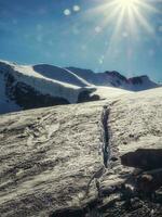 A fault in a glacier, a dangerous crack in the ice on the snowy slope of a glacier. photo