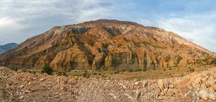 Panoramic view of the red mountain cut by canyons. photo