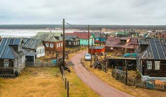 A small authentic village on the White sea coast. Kashkarantsy fishing collective farm. Kola Peninsula. photo