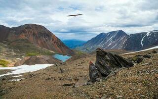 Panoramic highland scenery with sharpened stones of unusual shape. Awesome scenic mountain landscape with big cracked pointed stones closeup under dramatic sky. Sharp rocks with cracks. photo