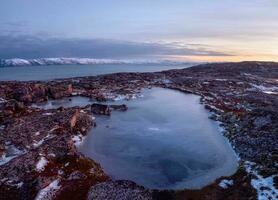 Cold winter dawn. The icy landscape and mountains in the Russian photo