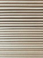Side view of a corrugated cardboard. Cardboard boxes are folded on a pallet. Corrugated cardboard sheets are one by one. photo