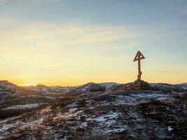 Cross on the Kola Peninsula, cold dawn in Teriberka photo