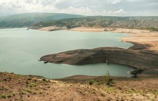 Cars on the beach. Remote view. Chirkeyskoe reservoir, Dagestan. photo