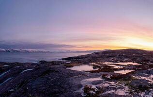 Amazing sunrise polar landscape with a white snow ridge of mount photo