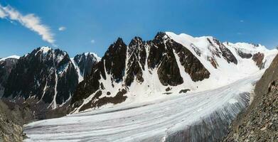 Wide panorama of the Big Aktru Glacier, high in the mountains, covered by snow and ice. Altai winter landscape. photo