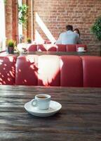 Café exprés taza en un de madera mesa en el interior de el café foto