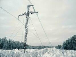 Power towers in the snow-capped mountains. photo