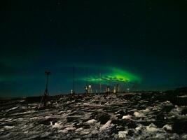 Old weather station. Night winter  polar landscape with the Aurora Borealis. photo