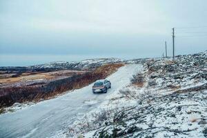 Slippery Arctic road through the hills. Winter Teriberka photo