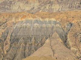 Cross section of rocks. Geological layers. Colored layers of stones in section of the mount, different rock formations and soil layers. photo