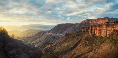 Matlas Valley at sunset in Dagestan. Rocky mountains and the light of the sun in the evening. photo