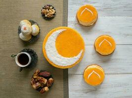 homemade golden cake with a Crescent moon, served with black coffee and dates photo
