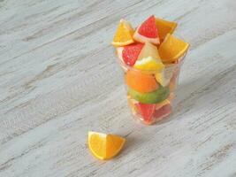 Vitamin C drink. Citrus slices in a clear glass. Strengthening the immune system concept photo