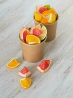 Vitamin C drink. Citrus slices in a environmental paper cups. Strengthening the immune system concept photo