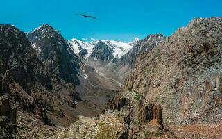 Panoramic view of dangerous couloir. Colorful sunny landscape with cliff and big rocky mountains and epic deep gorge. Altai Mountains. photo