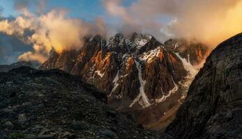 Majestic glacier is illuminated by the bright golden evening sun. Panoramic view. Altai Mountains. photo