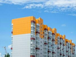 Modern beautiful new buildings. Colored wall on the background of blue sky. photo