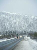 Winter snow road on the Kola peninsula. Traffic of cars. photo