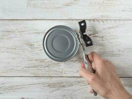 The key for opening an iron tin can in your hands photo
