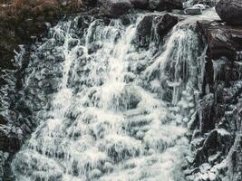 Frozen mountain waterfall. Waterfall with ice. Winter background photo