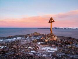 Poklonny Pomorsky cross on the hill of the Kola Peninsula. An old Russian fishing northern tradition. photo