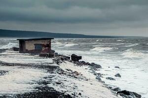 Stormy winter waves on the White Sea. Dramatic seascape. photo