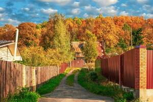 Dead-end village autumn street. Rural farmstead. photo