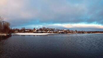 Panoramic winter view with old houses near a snow-covered lake. Authentic Northern city of Kem in winter. Russia photo