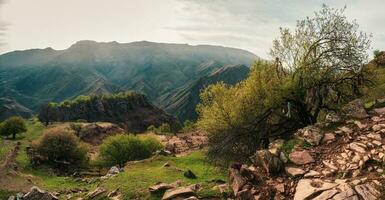 Colorful summer landscape with silhouettes of big rocky mountain photo