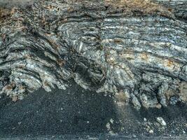 Stone texture. Colored layers of stones in section of the mount, different rock formations and soil layers. photo