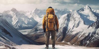 The closeup view of a man with backpack who stand in front of high mountain with . photo