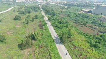 aerial view of highway between trees and green open space video