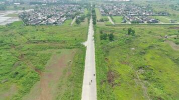 aerial view of highway between trees and green open space video