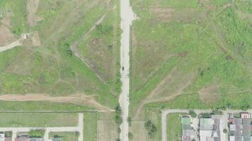 aerial view of highway between trees and green open space video