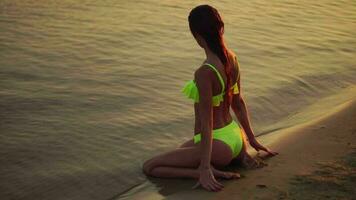 young lady in swimsuit at sunset at the warm evening video