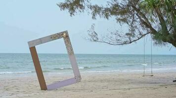 white photo frame with sand, sea and tree background, for advertising copy space of video, on a summer beach scene background. video