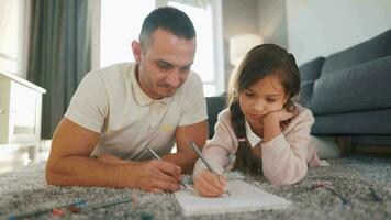 Father and daughter are having fun and painting together. Concept of a happy family and quality leisure time video