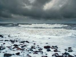 Stormy winter waves on the White Sea. Dramatic seascape. photo