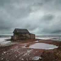 An old fishing shed on the Tersk shore. photo