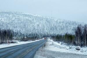 Snow pass. Winter Arctic road through the hills photo