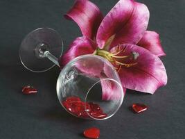 Close-up of red lily flower in a glass vase on a black background photo