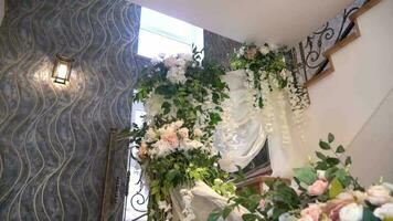spiral staircase in the interior with flowers. decor with flowers on the stairs.  wedding decorations video