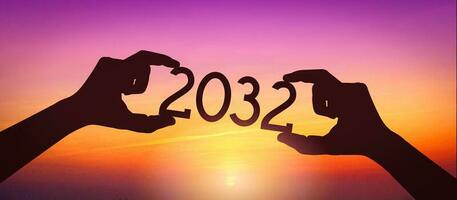 2032 - Human Hands Holding Black Silhouette Year Number photo