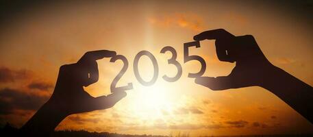 2035 - Human Hands Holding Black Silhouette Year Number photo