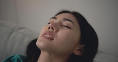 Asian Young woman sleeping on sofa in living room photo