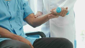 Physiotherapist working with patient in clinic, closeup video