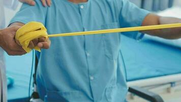 Physiotherapist working with patient in clinic, closeup video